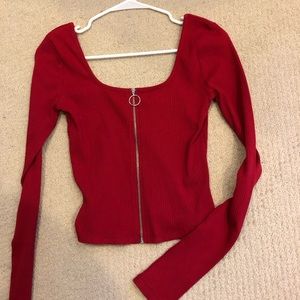 Red zip up long sleeve cropped shirt.